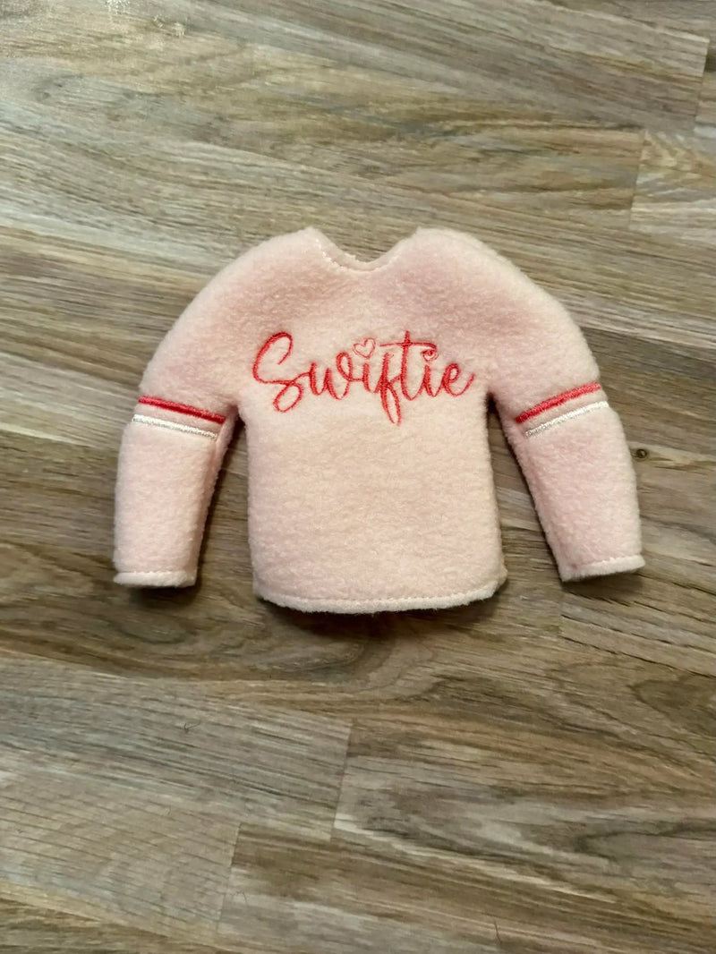 Light pink Swiftie Elf sweater 